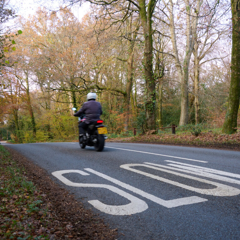 Motorbike on road with slow sign