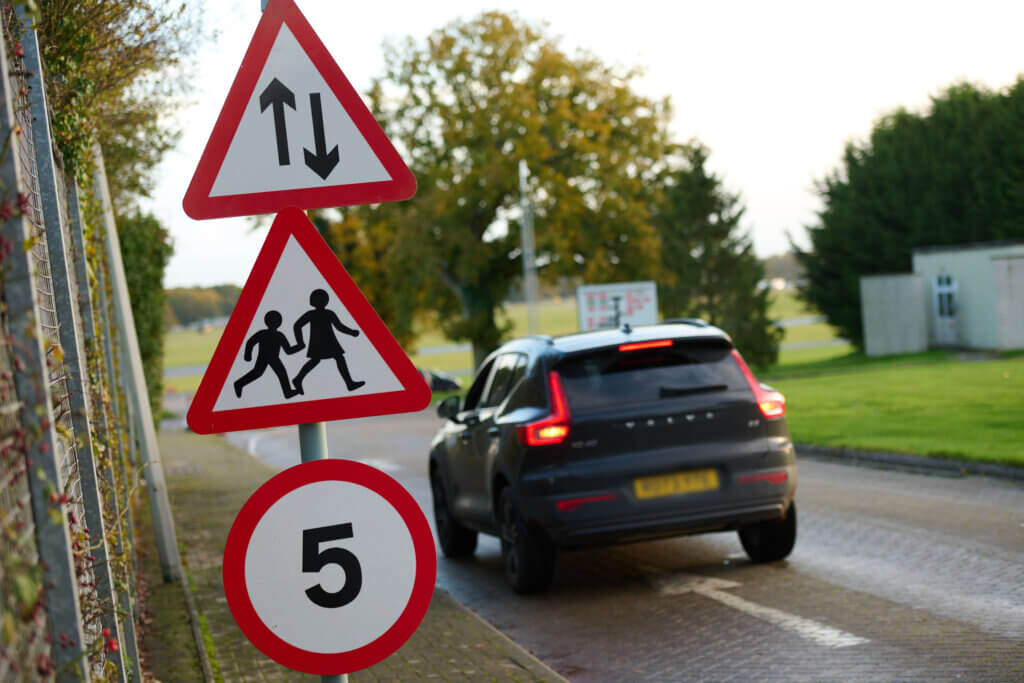 Car driving past signs