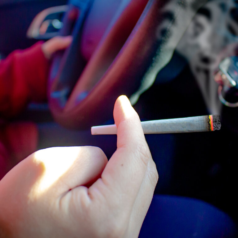 Person With Cannabis Joint Smoking And Driving
